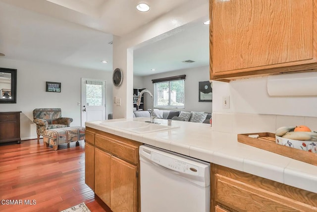 kitchen with dark hardwood / wood-style flooring, sink, tile countertops, and white dishwasher