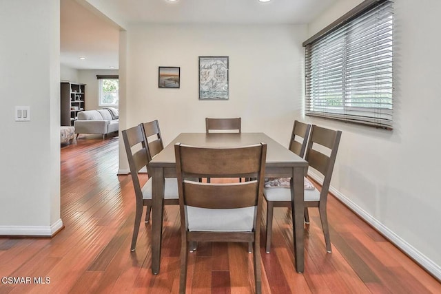 dining space with wood-type flooring