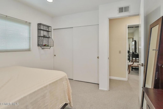 carpeted bedroom featuring a closet