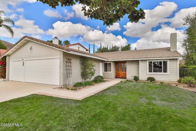 single story home featuring a garage and a front yard