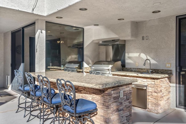 view of patio featuring area for grilling and an outdoor wet bar