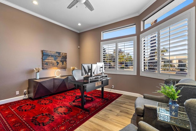 office area with wood-type flooring, ornamental molding, and ceiling fan