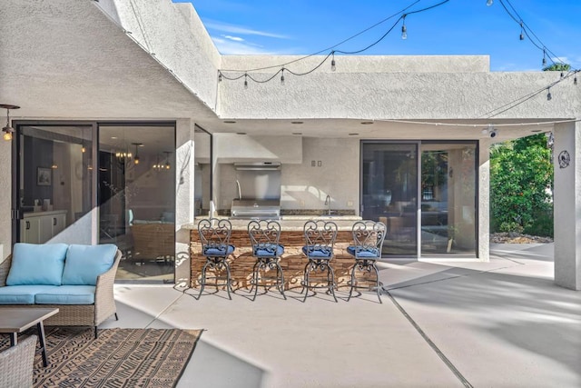 view of patio featuring outdoor lounge area and an outdoor bar