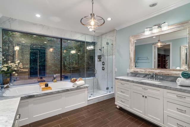 bathroom featuring crown molding, vanity, separate shower and tub, and backsplash