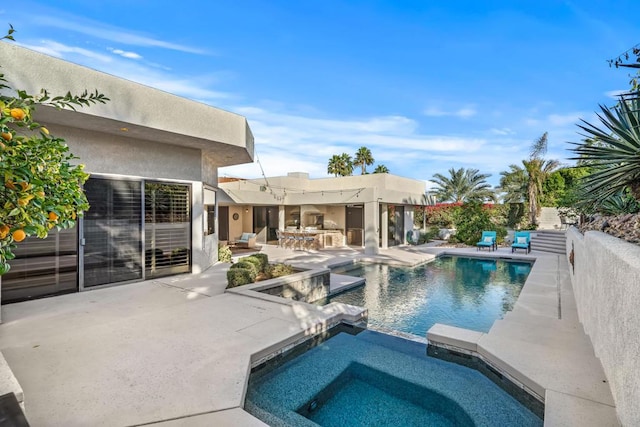 view of pool with an in ground hot tub and a patio