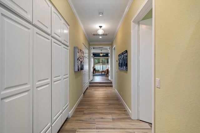 hallway featuring light hardwood / wood-style flooring and ornamental molding