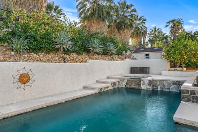 view of pool featuring an in ground hot tub