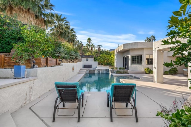 view of pool featuring pool water feature and a patio area