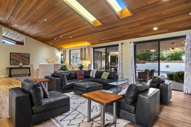 living room featuring vaulted ceiling with skylight, wooden ceiling, and light hardwood / wood-style flooring