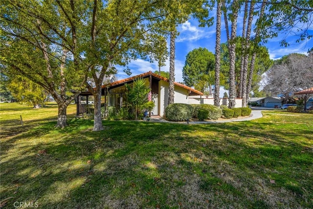 view of side of home with a lawn