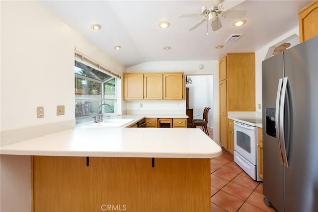 kitchen with sink, a kitchen breakfast bar, stainless steel fridge, kitchen peninsula, and white range with electric stovetop