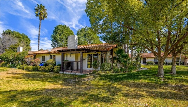 rear view of property with a yard