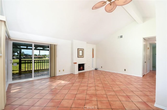 unfurnished living room featuring high vaulted ceiling, a brick fireplace, light tile patterned floors, beamed ceiling, and ceiling fan