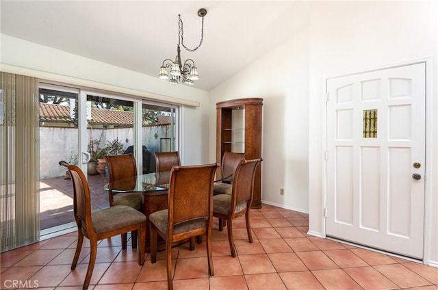 tiled dining room featuring a notable chandelier and vaulted ceiling