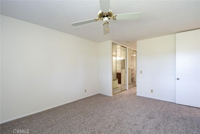 unfurnished bedroom with ensuite bath, ceiling fan, and carpet flooring