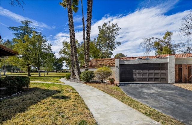 exterior space with a garage and a front lawn