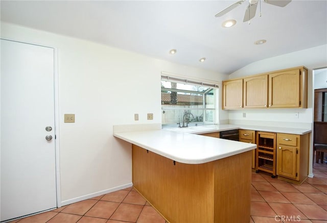 kitchen with lofted ceiling, sink, light tile patterned floors, ceiling fan, and kitchen peninsula