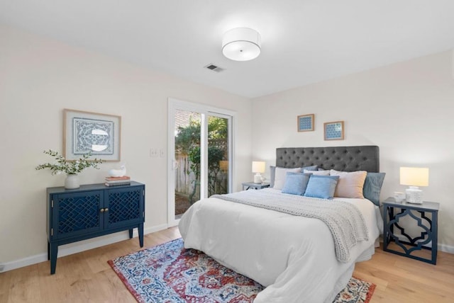 bedroom featuring access to exterior and light hardwood / wood-style floors