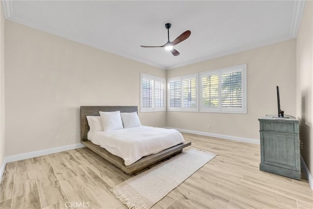 bedroom with ceiling fan, ornamental molding, and light hardwood / wood-style floors