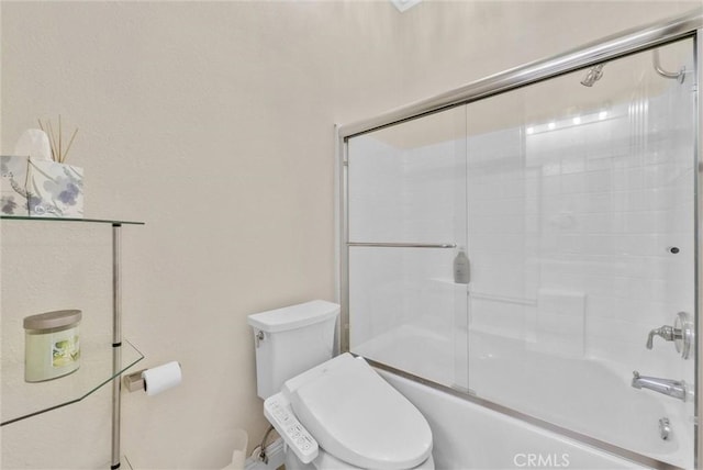 bathroom with bath / shower combo with glass door and toilet