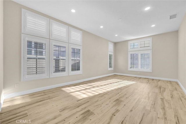 spare room with light hardwood / wood-style flooring