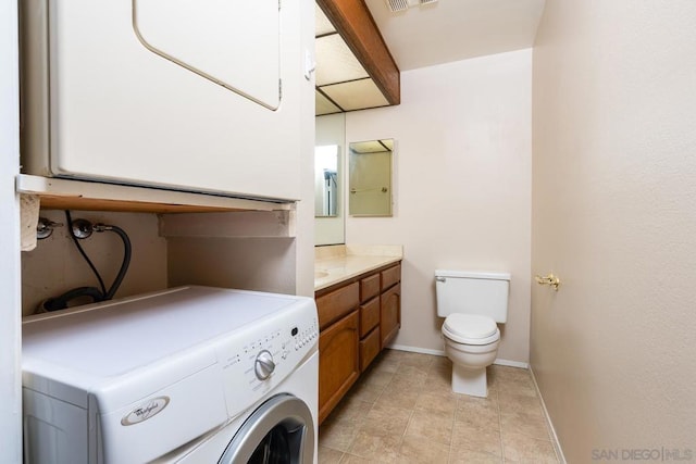 bathroom with tile patterned floors, stacked washer / drying machine, toilet, and vanity