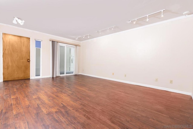 unfurnished room featuring dark wood-type flooring and ornamental molding