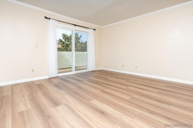 spare room with crown molding and light hardwood / wood-style flooring