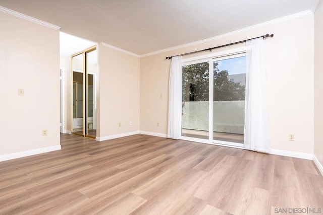 empty room with crown molding and light hardwood / wood-style flooring