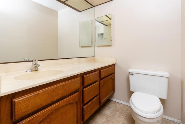 bathroom featuring tile patterned flooring, vanity, and toilet