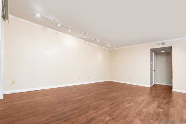 unfurnished room featuring crown molding and dark wood-type flooring