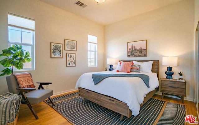 bedroom with wood-type flooring