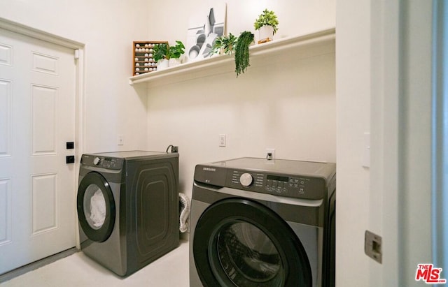 clothes washing area featuring washer and clothes dryer