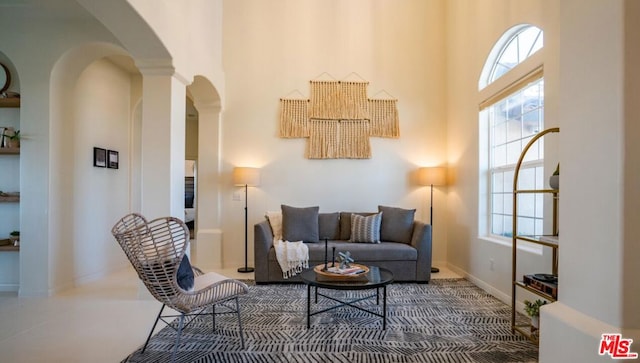 living room featuring plenty of natural light and a towering ceiling