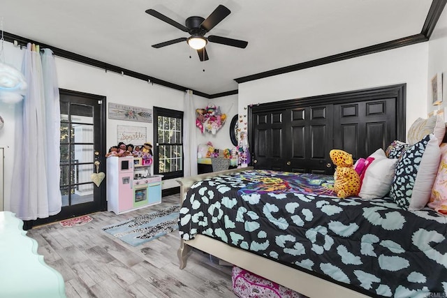 bedroom with crown molding, ceiling fan, and wood-type flooring