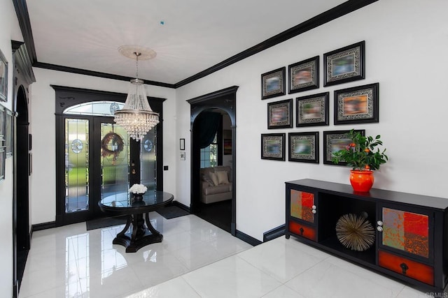 foyer entrance featuring an inviting chandelier, ornamental molding, and a wealth of natural light