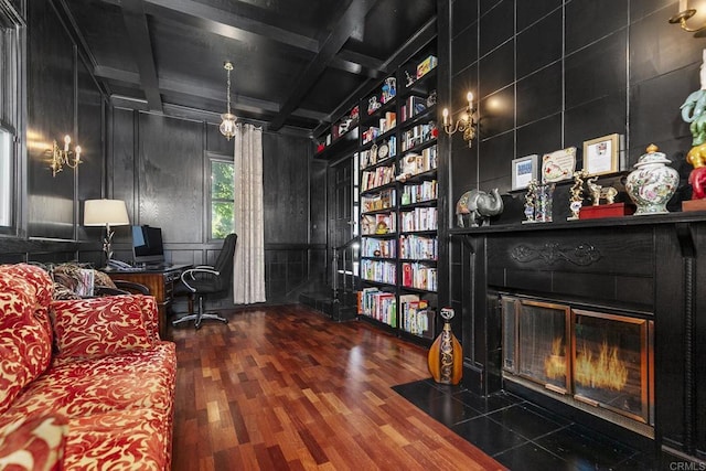 office featuring built in features, beam ceiling, coffered ceiling, wood-type flooring, and a large fireplace