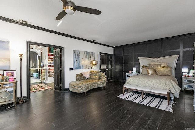 bedroom featuring hardwood / wood-style flooring, ceiling fan, and crown molding