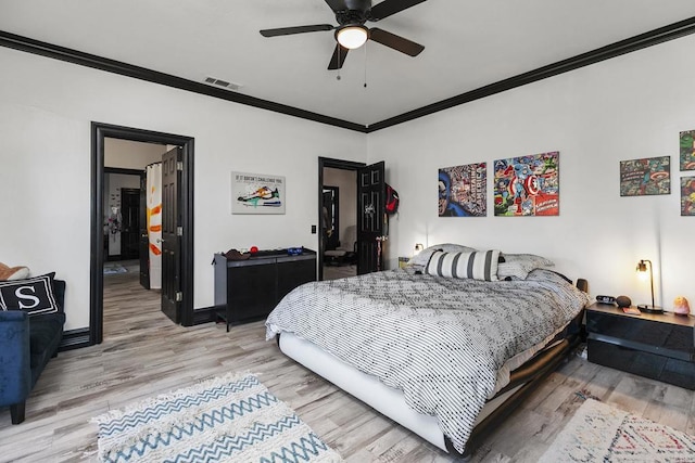 bedroom featuring wood-type flooring, ornamental molding, and ceiling fan