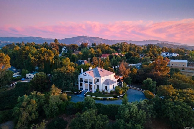 aerial view at dusk featuring a mountain view