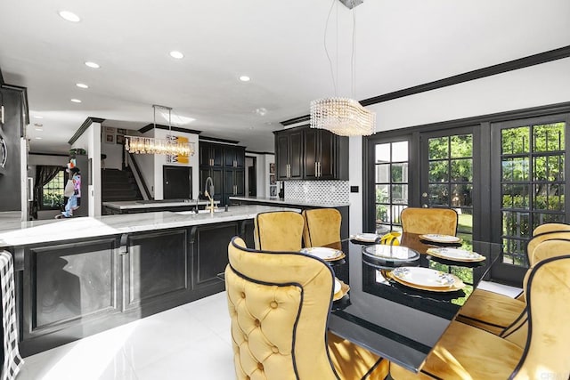 dining room with crown molding and sink