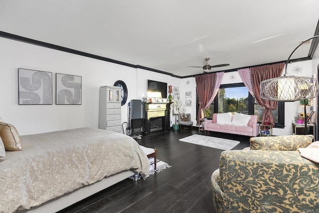 bedroom featuring hardwood / wood-style flooring, crown molding, and ceiling fan