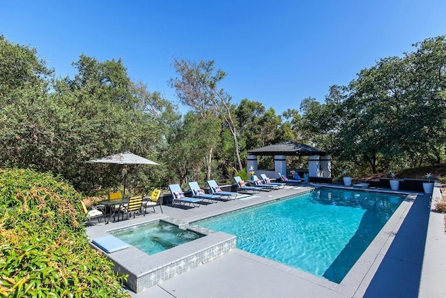 view of swimming pool featuring an in ground hot tub, a gazebo, and a patio area