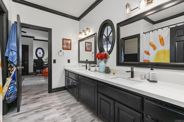 bathroom featuring vanity, crown molding, and wood-type flooring