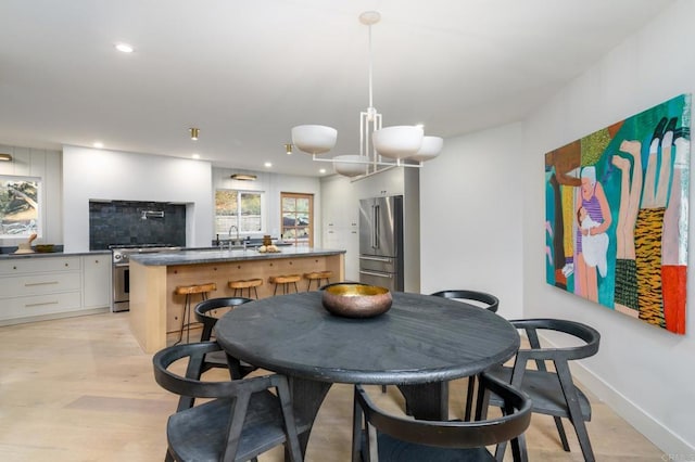 dining area featuring light hardwood / wood-style floors and sink