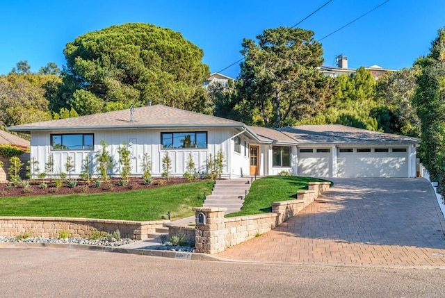 ranch-style home featuring a garage and a front yard