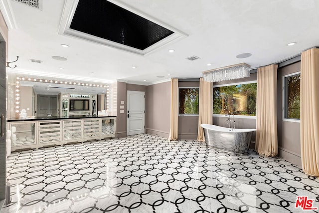 bathroom with ornamental molding, vanity, and a washtub