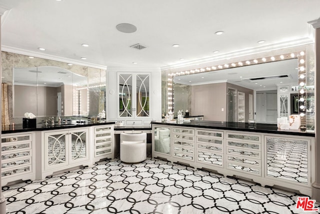 bathroom with ornamental molding and vanity