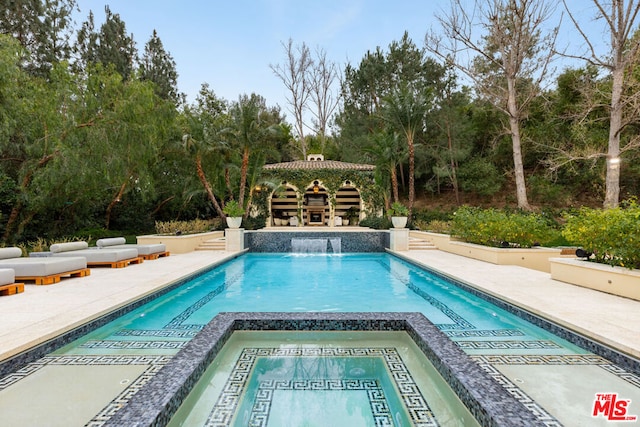 view of swimming pool featuring a gazebo and an in ground hot tub