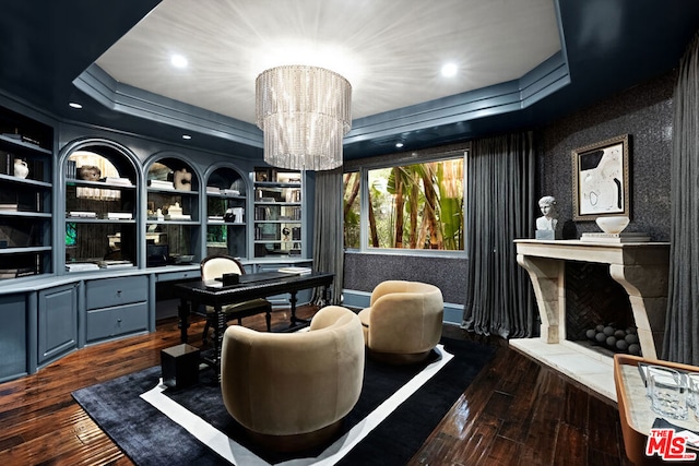 office area featuring built in desk, built in features, dark hardwood / wood-style floors, and a chandelier